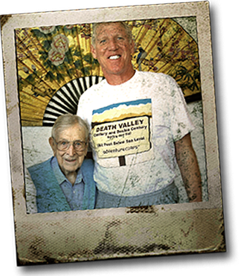 Adult Bill Walton next to aged Coach