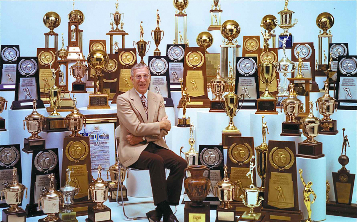 John Wooden with trophies