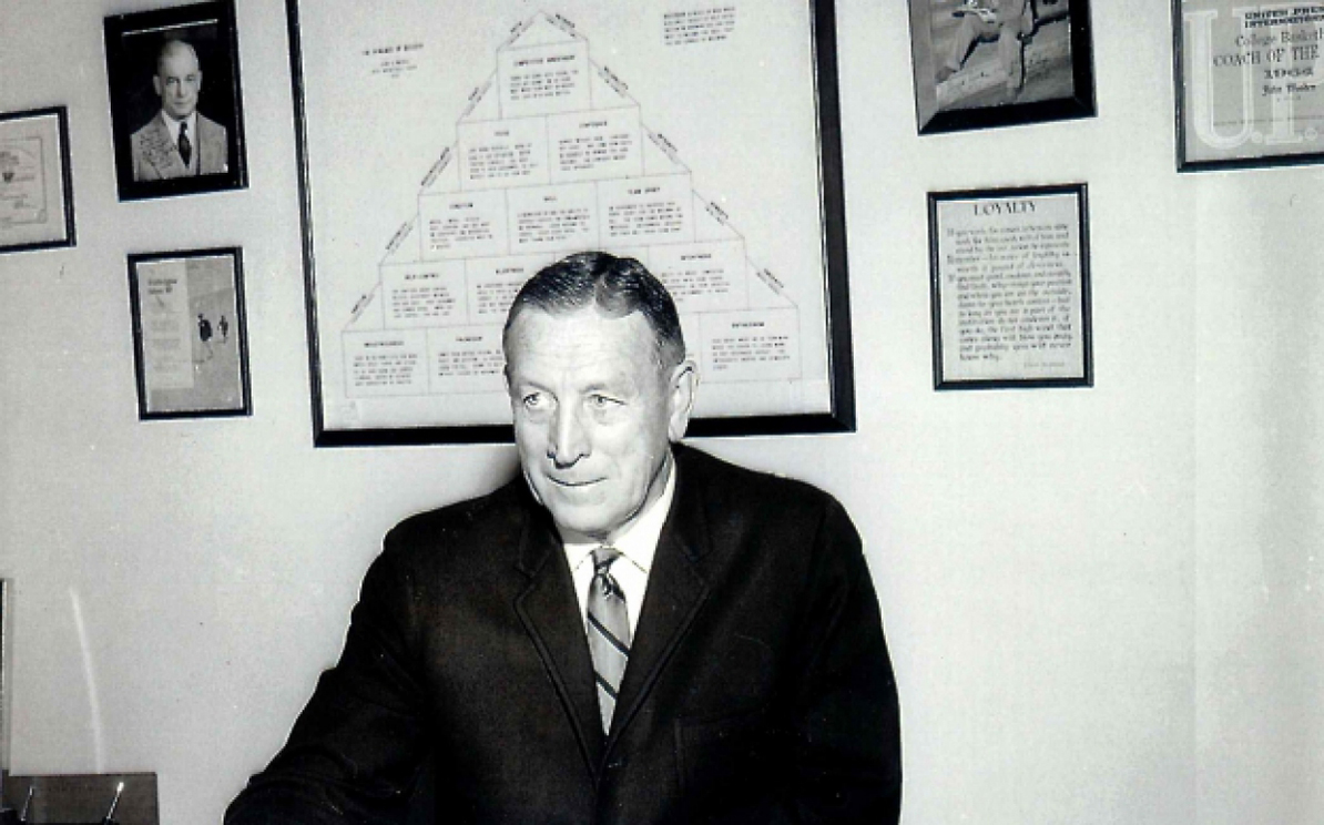 JW at desk with pics of piggy and the fox on wall