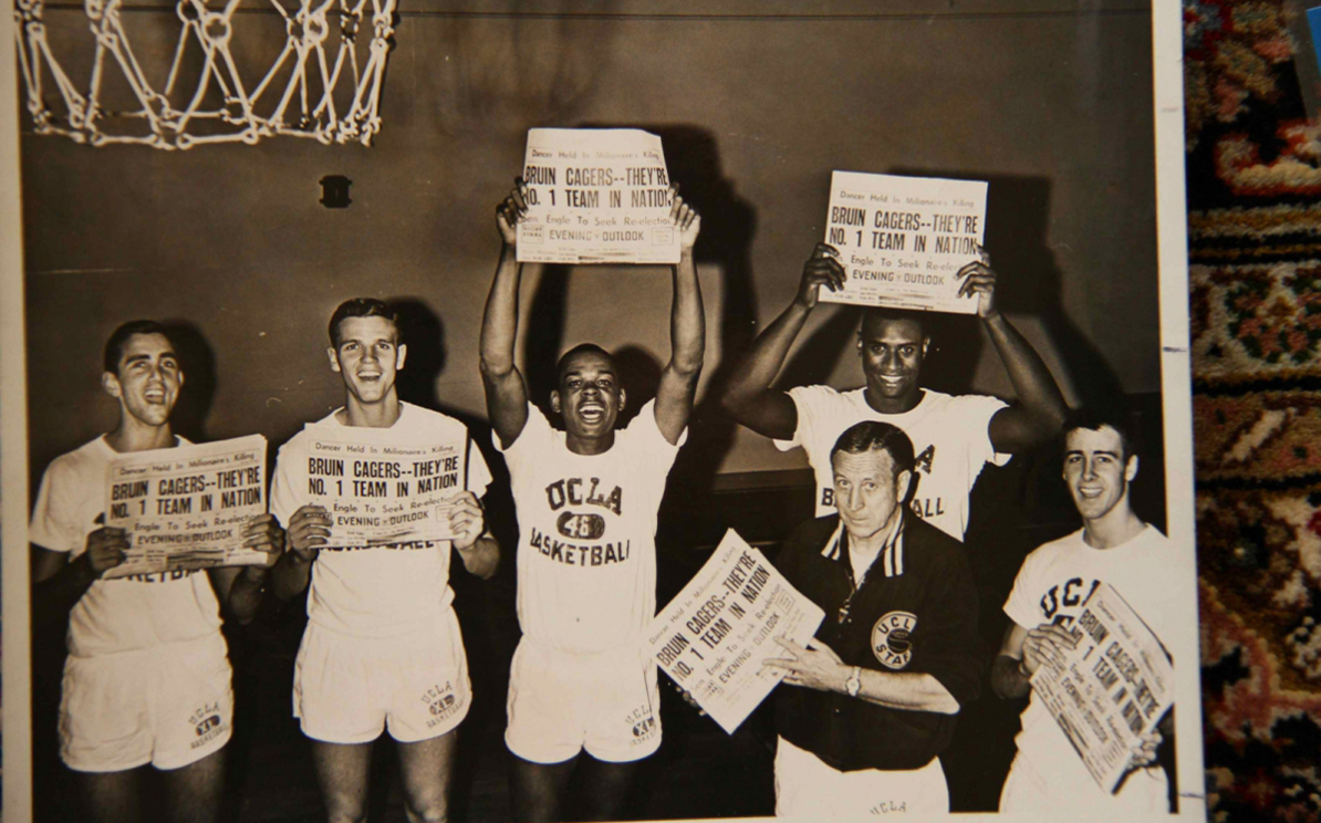 Nat. champ team holds newspapers