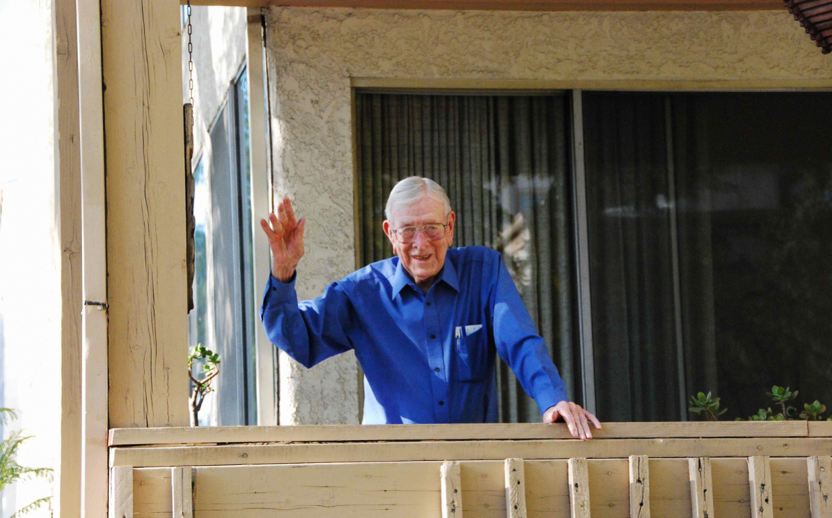 JW waving hello from porch